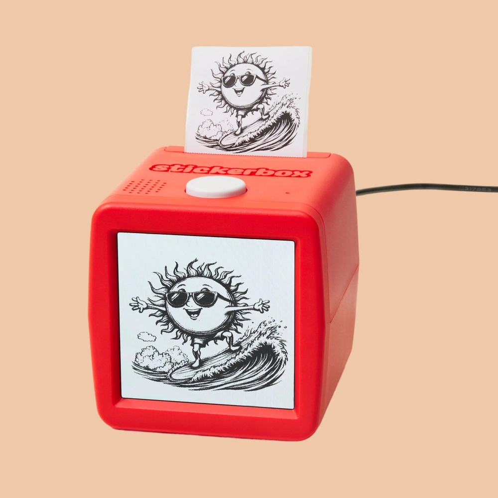 A Stickerbox printing a black-and-white sticker of a sun wearing sunglasses