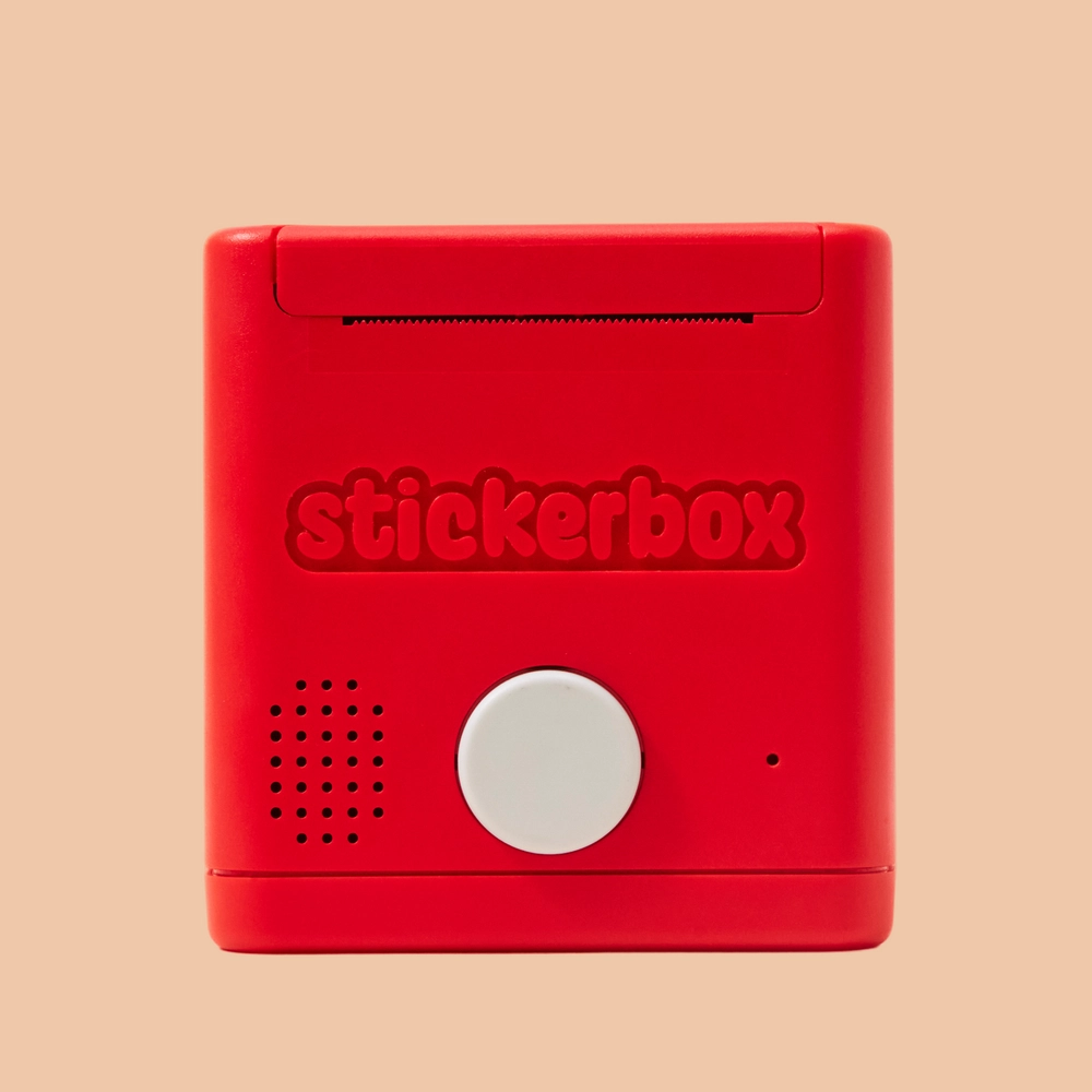 The red Stickerbox seen from the back, with its speaker grille and white button
